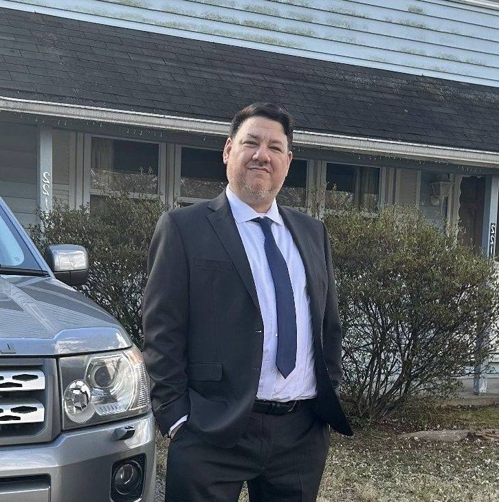 An image of Liam P. Ward in a suit